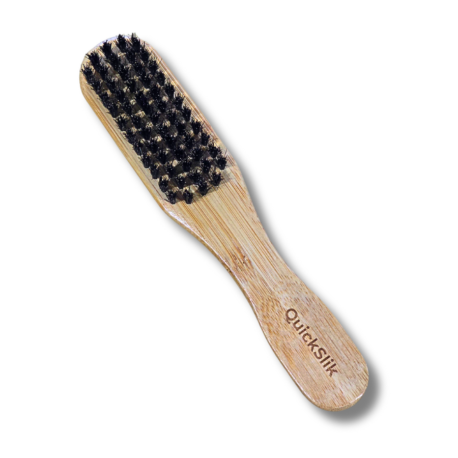 Wooden brush with black bristles on a white background, branded 'Quickslick'.